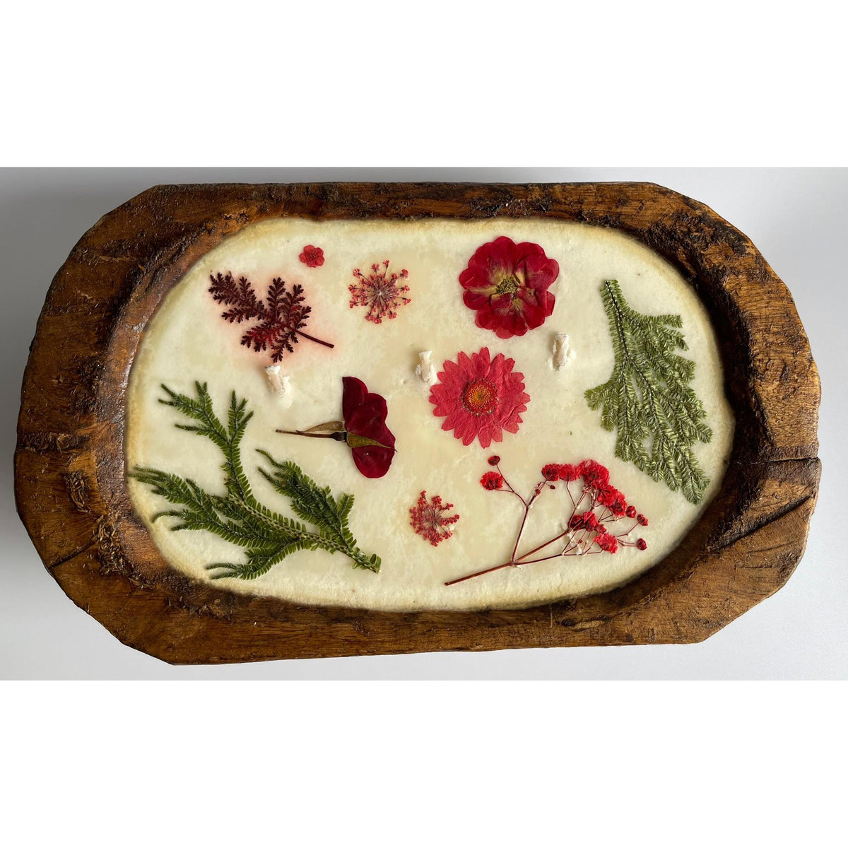 Soy candle with pressed flowers in natural reusable wood dough bowl