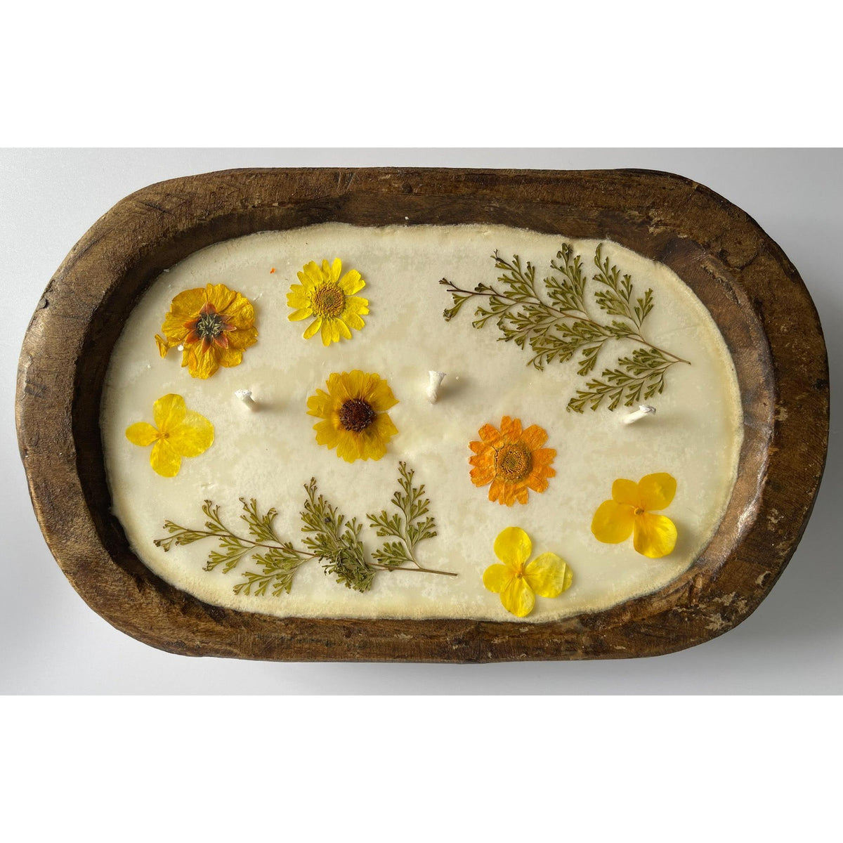 Soy candle with pressed flowers in natural reusable wood dough bowl